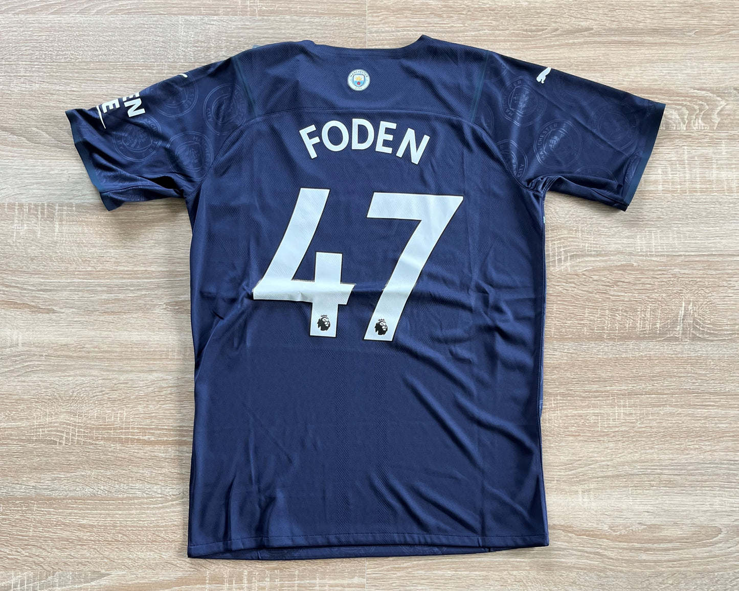 Manchester City Third Shirt from 2021-2022: Player Spec, Worn by Foden with the number 47, this jersey signifies Manchester City's alternate kit during the 2021-2022 season. With its distinctive design and player-specific features, it captures both the team's style and Foden's individuality on the field.