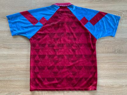 Aston Villa Home Shirt from 1990-1992: The classic home jersey worn by Aston Villa during the 1990-1992 period. Featuring the club's emblem and a traditional design, this shirt captures the essence of the team's representation and efforts on the field during that specific era.